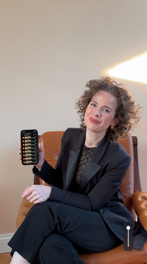 Ivy with phone showing sales